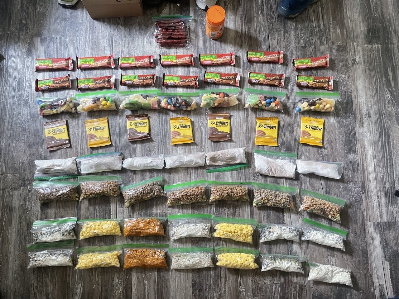 A week of backpacking food portioned into bags for one BearVault BV475 bear canister load on the John Muir Trail