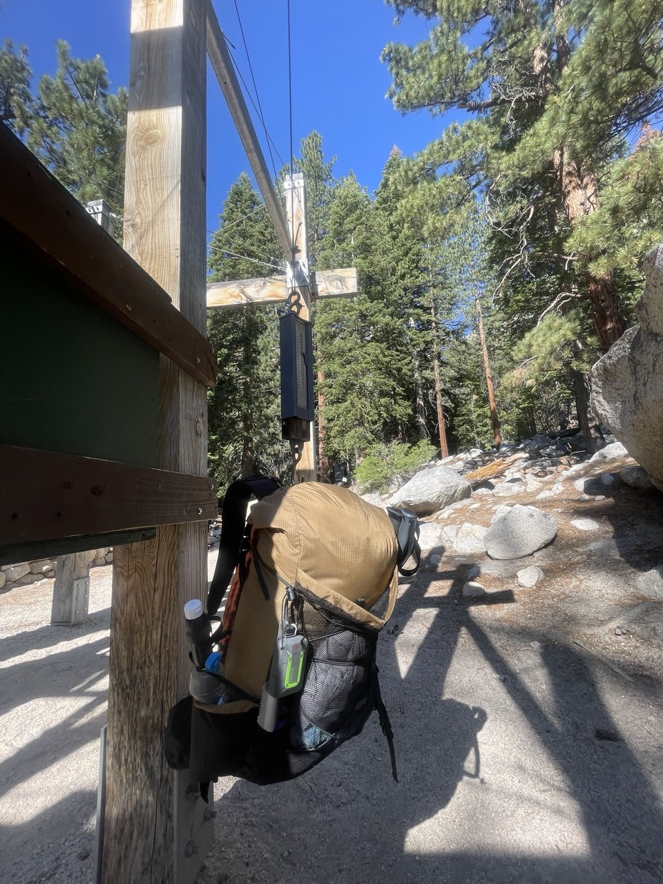 Backpack hanging from the hiker scale at Whitney Portal reading 35 pounds at the start of a northbound John Muir Trail thru-hike