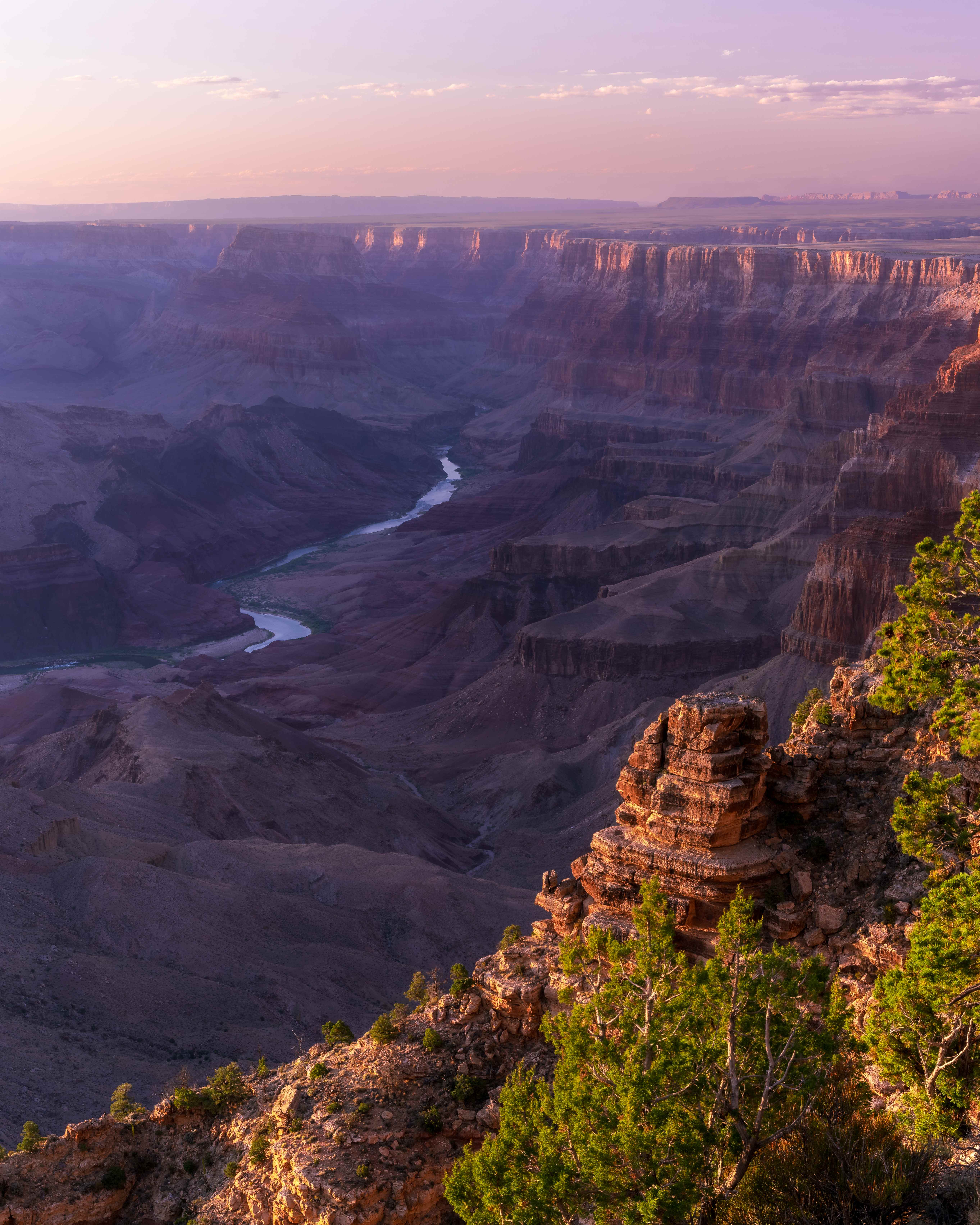 Wide view from Desert View, last light catching the far rim beneath a purple sky.